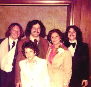 Surrounded by her best audience and her most willing court jesters, 1976