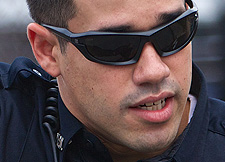 Nice wraparounds officer. Must be a tactical necessity when working the afterschool crossing guard detail. You're not on TV, dumass.  Try acting like you're at work. 